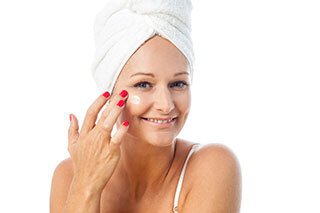 model with hair wrapped in towel